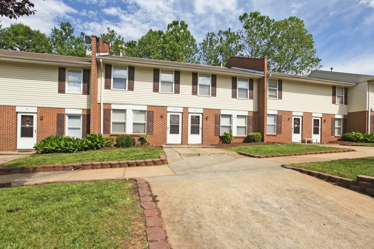 Gretna Village, Gretna, VA — a row of brick and cream-sided townhomes under a clear sky